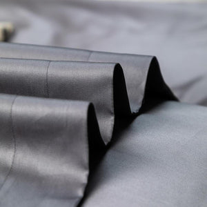 close up of gray bed sheets.