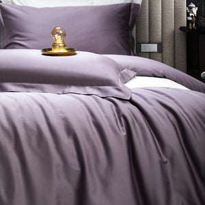 Close up of purple bedding sheets with the pillow covers. Pillow covers do not contain filling.