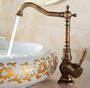 Antique Farm Bathroom Faucet with open water flow on marble farm sink.